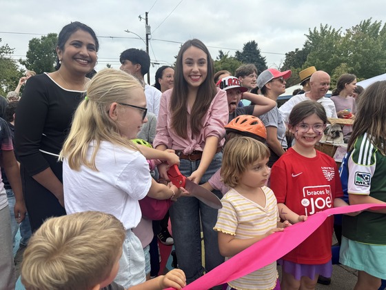 City Councilor Angelita Morillo, Deputy City Administrator Priya Dhanapal, and Roseway Children cut the ribbon at the Roseway Plaza