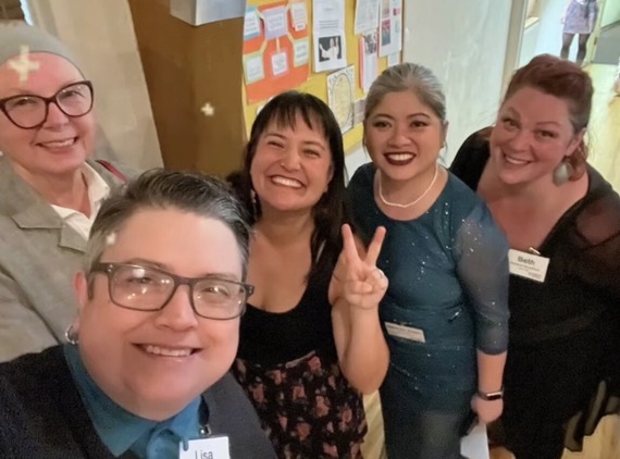 Five people smiling up at the camera