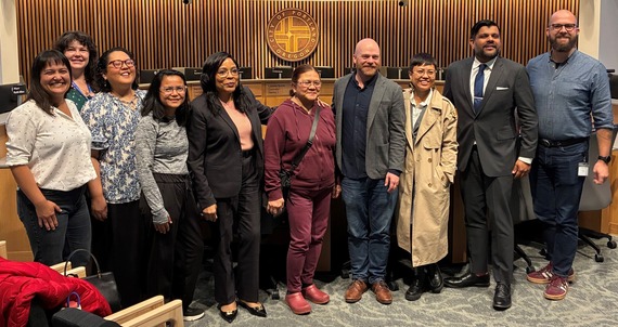 Line of people, including councilors Koyama Lane, Smith, Green, Kanal and Dunphy, in City Council Chambers.