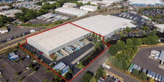 Birds-eye photo showing the Cutter Garage on Swan Island with the Willamette River in the background. Photo credit: Macadam Forbes.
