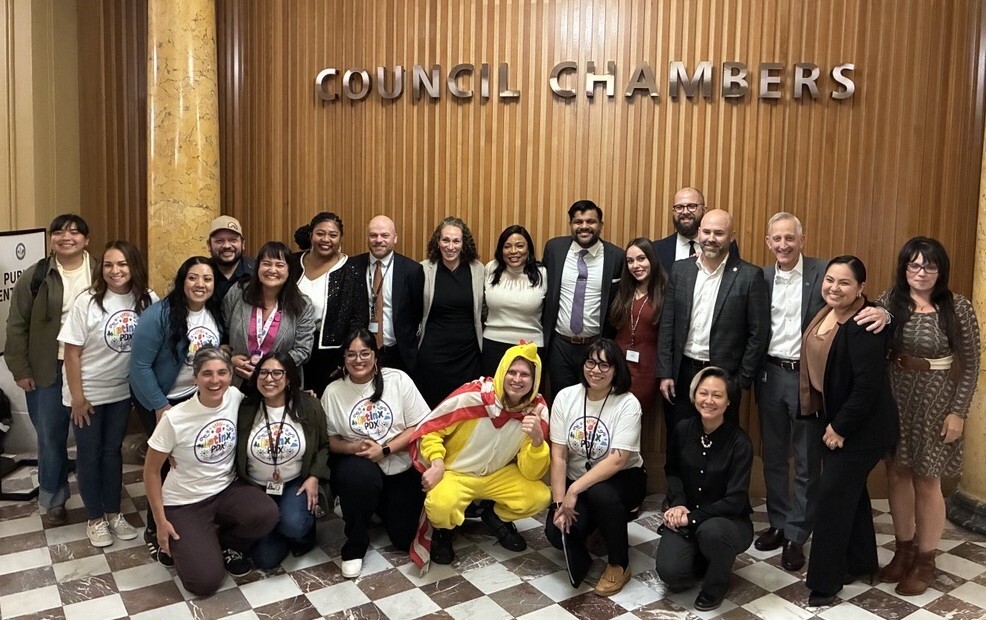 Group of smiling people, including city councilors, Mayor Wilson, staffers, and members of community partners Latinx PDX and ACLU of Oregon