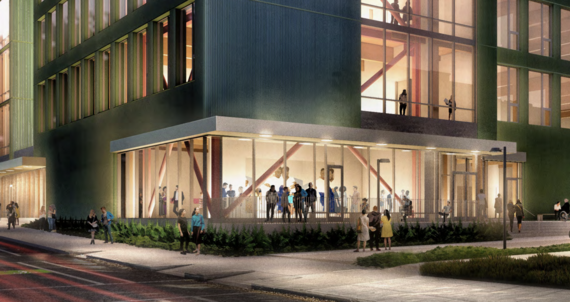 New building with large windows and people gathering inside and outside