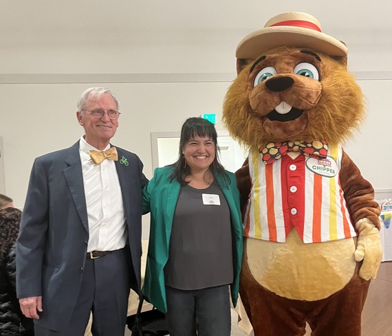 Earl Blumenauer, Councilor Koyama Lane, and Chipper the Squirrel, the mascot of Oaks Park, smiling at the camera