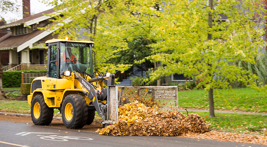 large utility truck picking up leaves