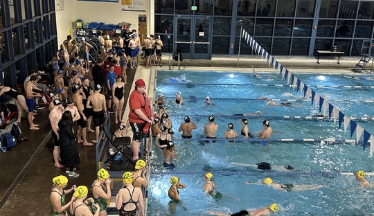 Youth swim club members doing warm ups at Matt Dishman pool 