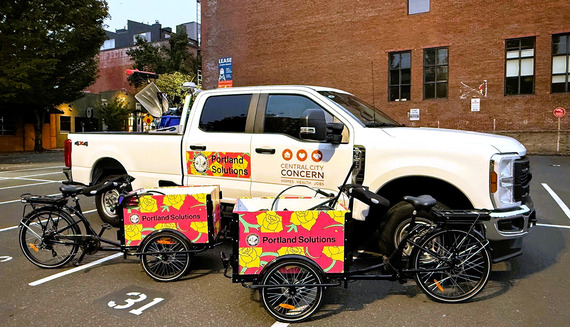 A photo shows a truck and two utility tricycles