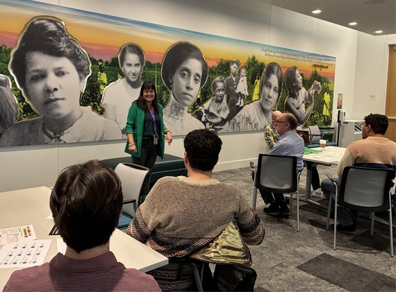 Councilor Koyama Lane speaking to group of people sitting in chairs