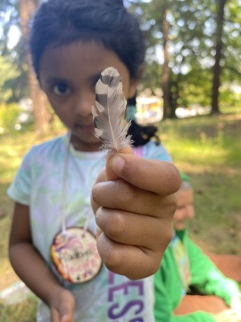 Girl holding feather for Parks Levy thank you