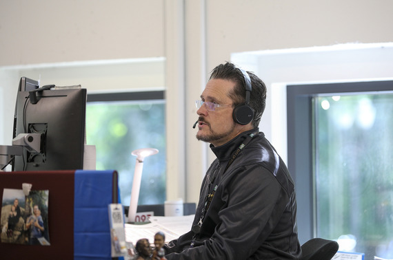 John Dutt of 311 program speaks on the phone through a headset