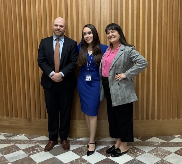 City Councilors Mitch Green, Angelita Morillo, and Tiffany Koyama Lane in front of wooden wall outside of Council Chambers