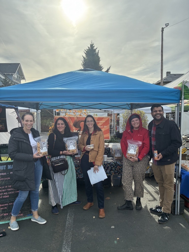 Council President Elana Pirtle-Guiney with fellow councilor and three individuals affiliated with the Portland Farmers Market