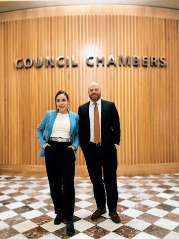 Councilor Morillo standing with Councilor Green outside Council chambers