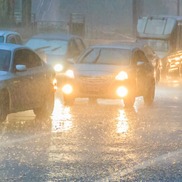 Winter rainy weather and cars with headlights