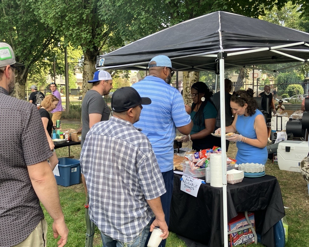 Council President Elana Pirtle-Guiney dishes up food for community members at a neighborhood block party.