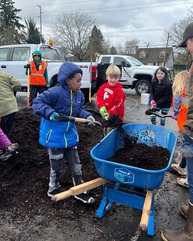 PPR - Group of kids shoveling mulch into a wheel barrow 