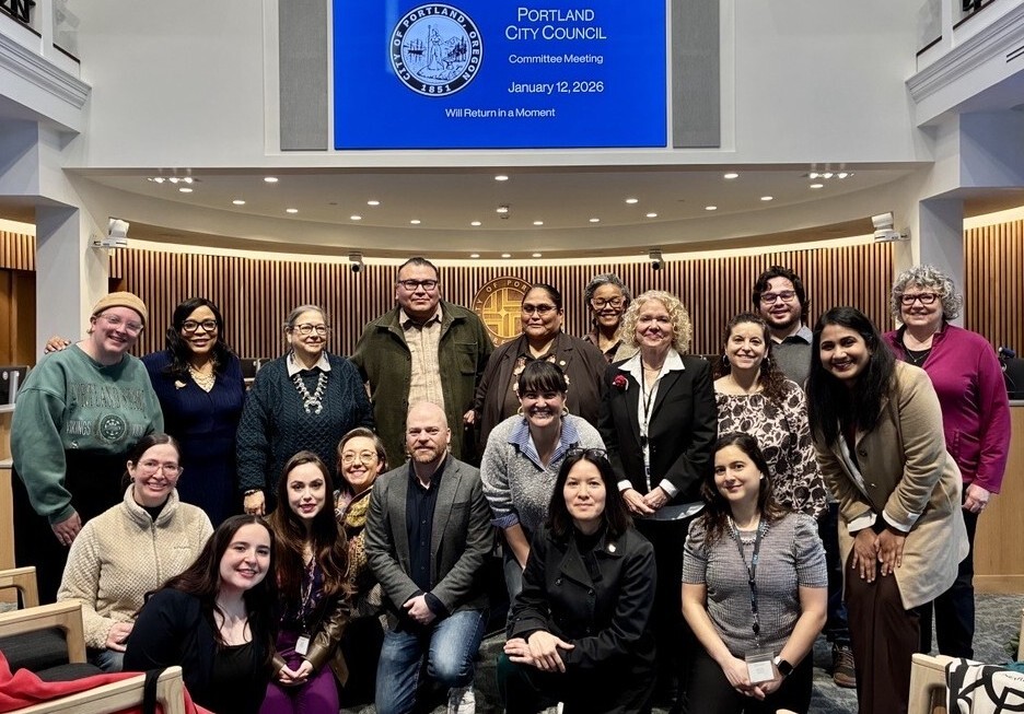 members of the Traffic and Infrastructure committee, city officials, and community leaders smiling at the camera in front of the council dais