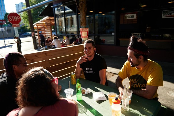 Four people seated at outdoor dining table
