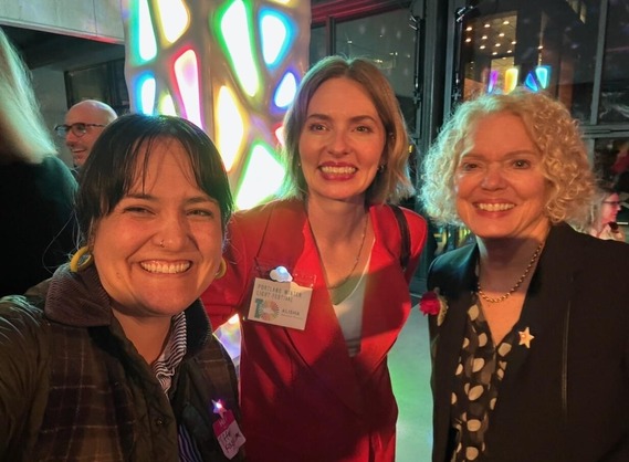 Councilor Koyama Lane, Portland Light Festival Executive Director Alisha Sullivan, and Councilor Olivia Clark in front of tower with colorful lights