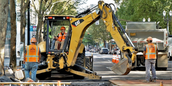 Public works employees digging in street