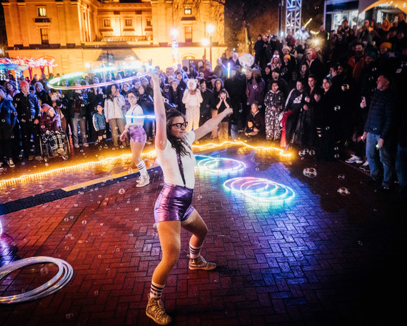 Portland Winter Light Festival with people hula hooping at night for a large audience