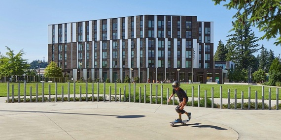 Needed housing image shows a affordable housing and a park in front of it