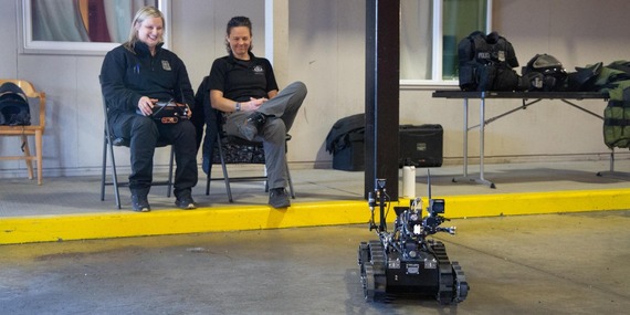 Two women operate a robotic vehicle for Women in Public Safety event