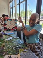PPR - Woman holding up picture of white leaf