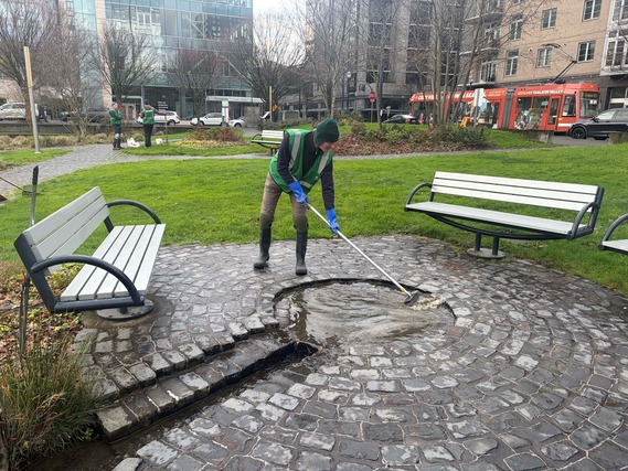Chad Kirkpatrick, a volunteer, helps clean a park