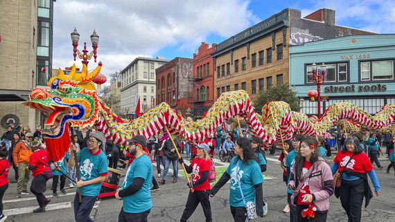A 150-feet long Chinese dragon puppet is carried on poles by people through the streets of downtown Portland
