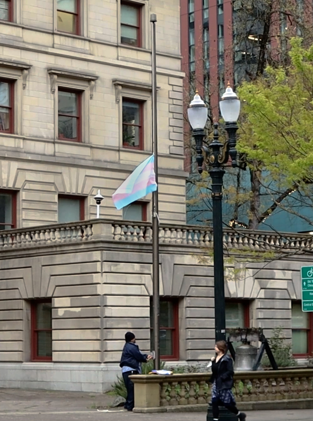 Transgender Pride flag that is pink and light blue, being raised at Cithy Hall