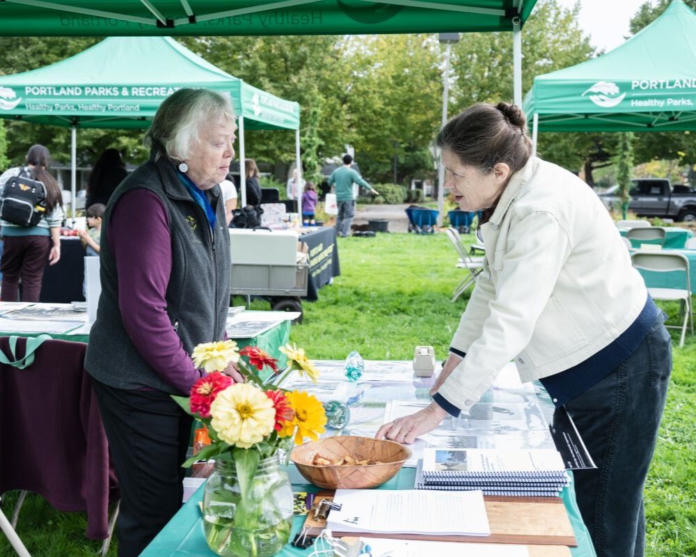 PPR - Twp people talking with a table between them 