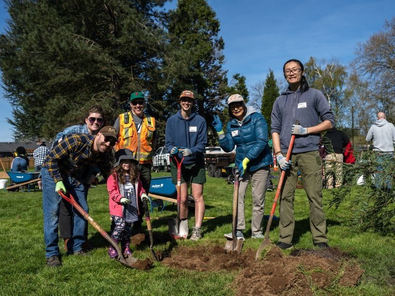 PPR - Group of people standing around newly planted tree 