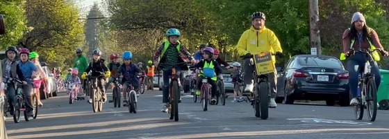 The James John Elementary School bike bus on the way to school, with ride leaders at the front followed by students.
