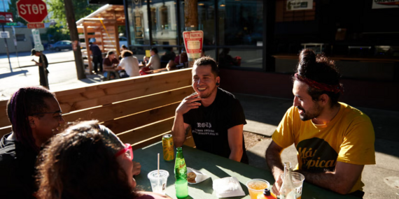 Four people enjoy outdoor street dining