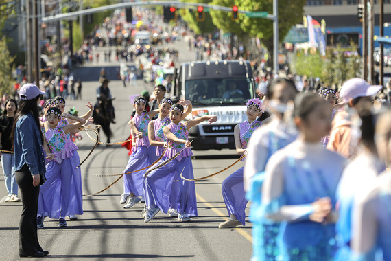 Chinese folk dance students perform along a parade route for 82nd Avenue of Roses Parade