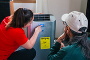 A technician with Cooling Portland helps install a cooling unit for a Portland resident