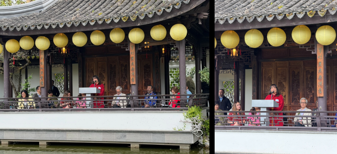 Line of people seated on terrace of a pavilion at Lan Su Chinese Garden, with Councilor Koyama Lane at lectern