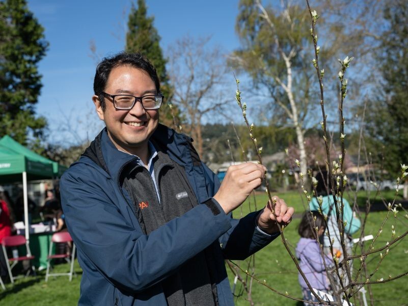 PPR - Man with glasses holding branches of small tree