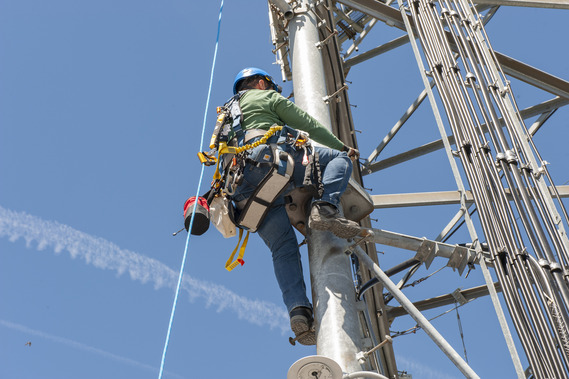 Staff from Bureau of Technology services conduct routine maintenance on the a radio tower located at Goat Mountain.