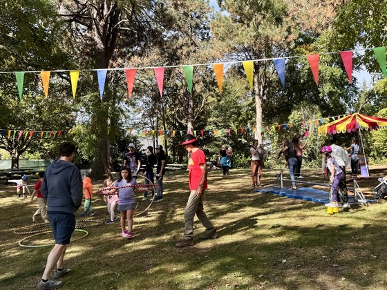 Sunday Parkways attendees enjoying circus activities with Circus Cascadia in a park during an event. 