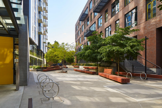brick building with plaza trees and bicycle racks