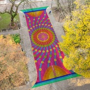 Rendering of an aerial view looking down at a colorful street mural in the Cultural District Plaza