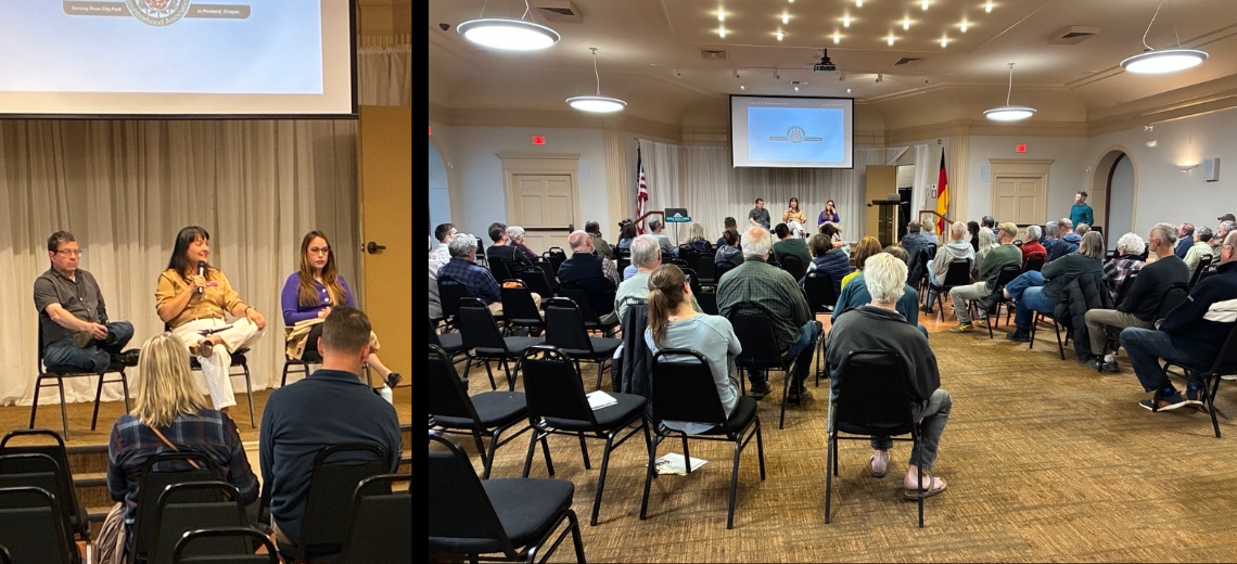 Councilors Novick, Koyama Lane, and Morillo in chairs on a stage, and a sizable crowd seated on chairs in a large room watching the discussion