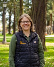 Heather is a parks maintenance supervisor - she is smiling at the camera