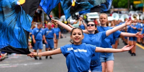 Fred Meyer Junior Parade photos shows young people twirling flags