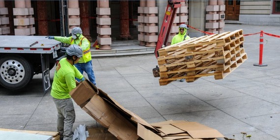 Procurement disparity study image shows a contractor stacking supplies in front of City Hall
