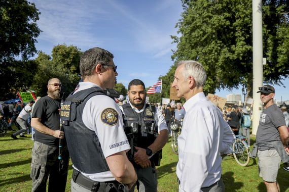 Mayor Keith Wilson stops to talk with Portland Police dialogue liaison officers at a protest