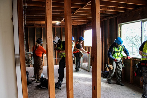 Volunteers deconstructing a building from the inside