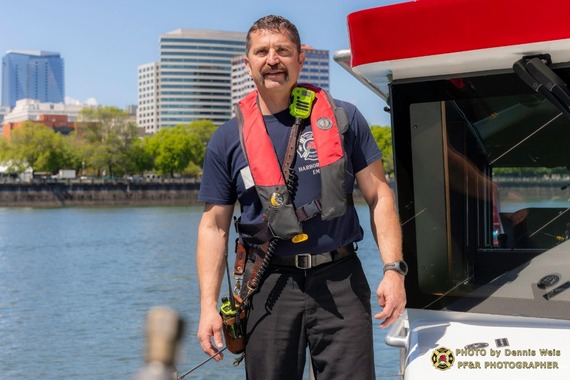 Harbor Pilot Colin McGladrey, Portland firefighter of the year, stands on a fireboat
