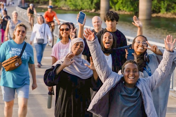 World Refugee Day Walk participants smile at the camera